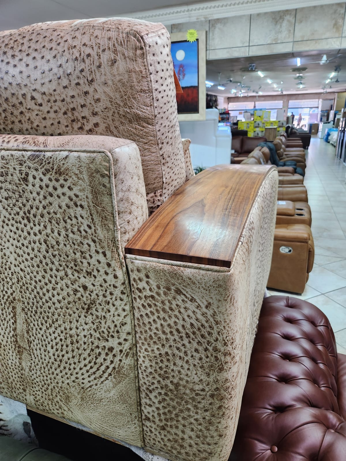 Back view of genuine ostrich leather sofa with walnut arms